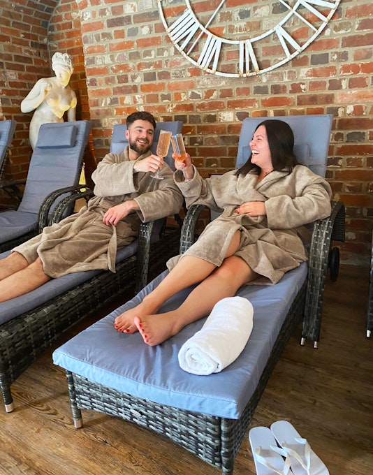 Seckford Hall Hotel and Spa Couple on Loungers with Fizz